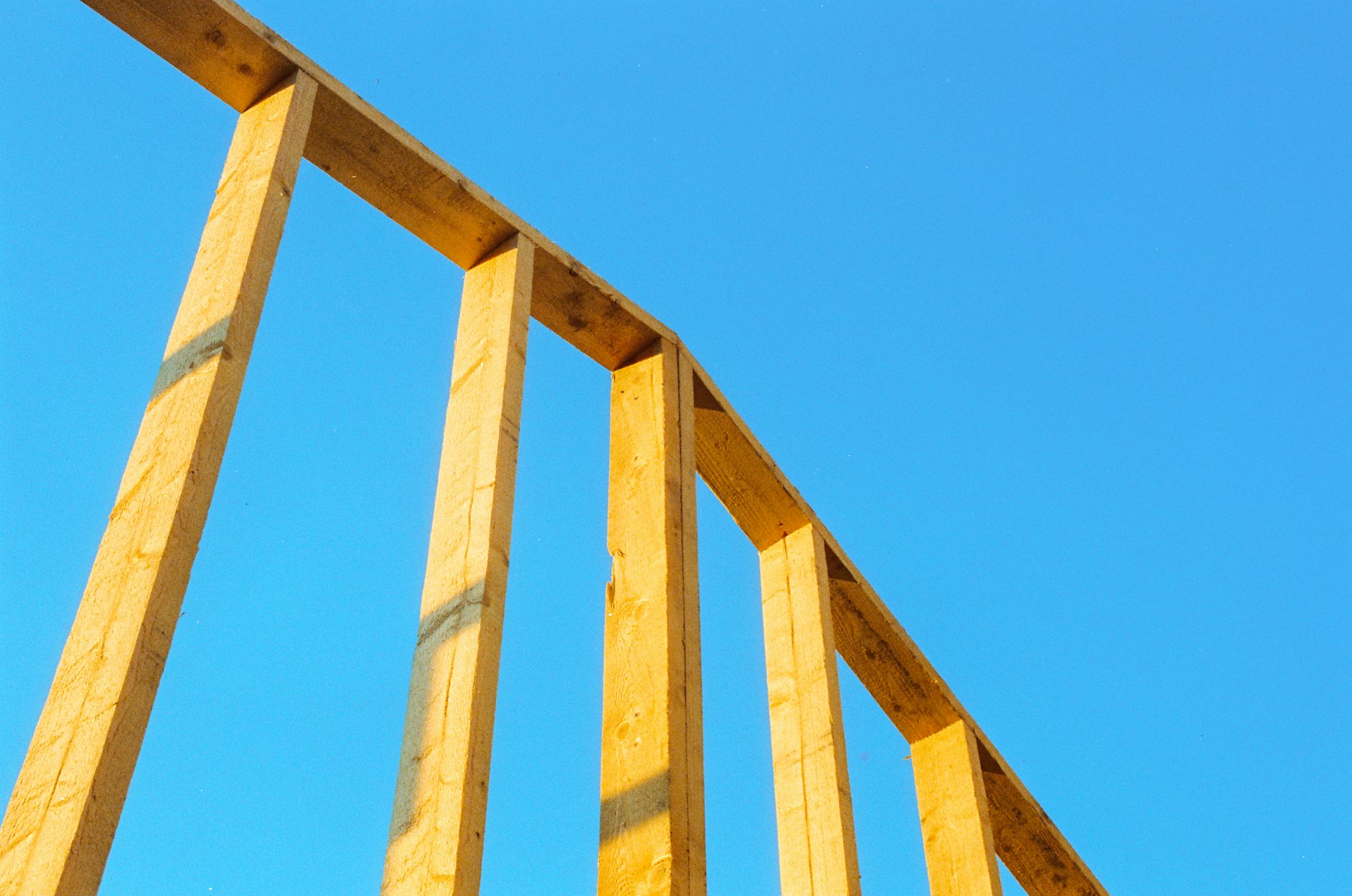 Wood framing against a blue sky