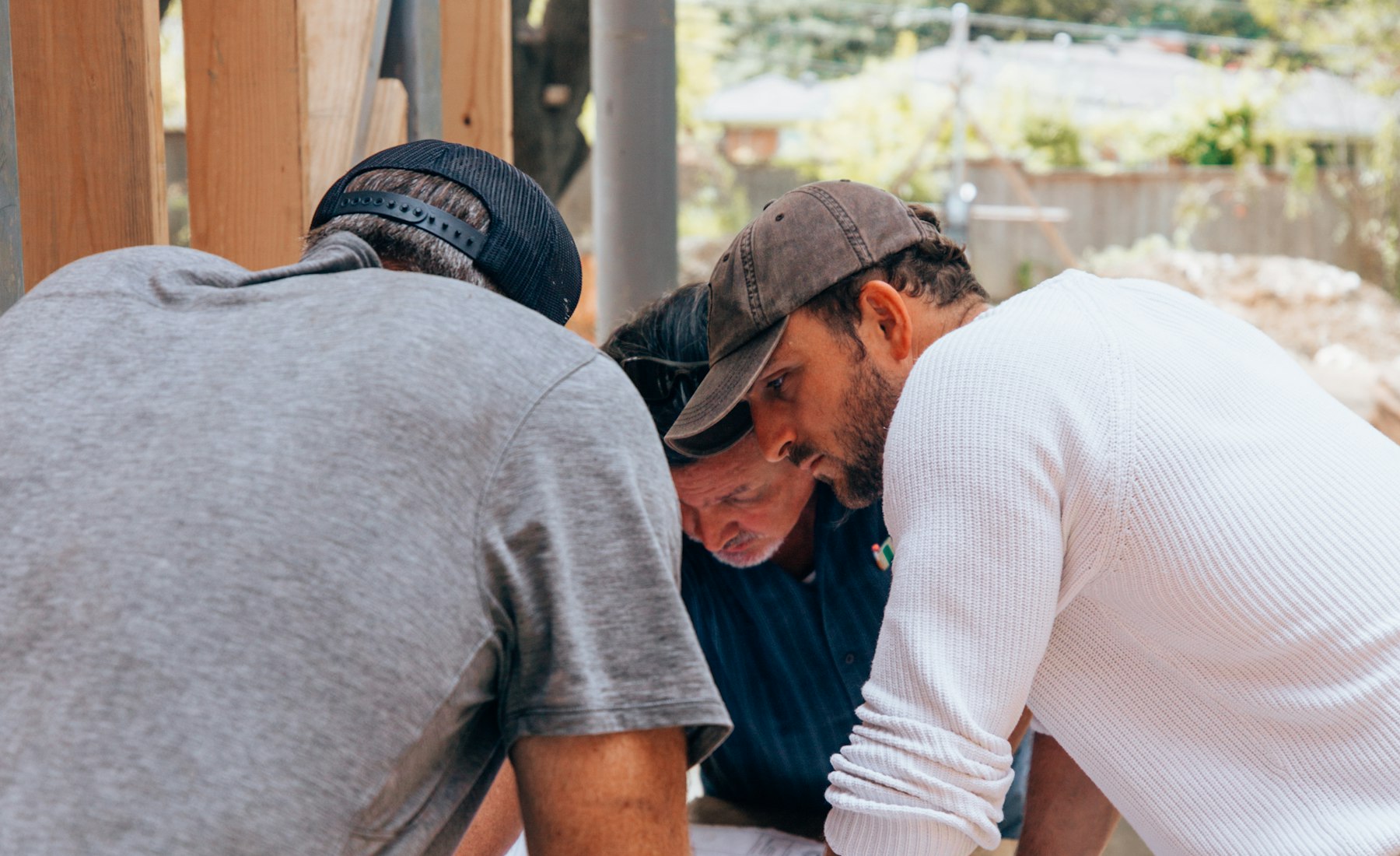 Crew reviewing blueprints on a job site